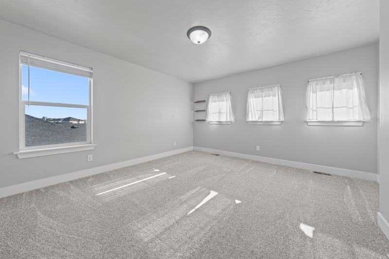 The primary suite has four windows, a walk-in closet, and a double vanity